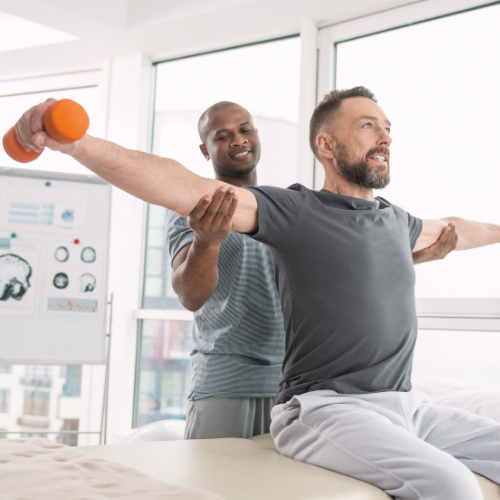 Therapist assisting a patient with a rehabilitation exercise in a supportive clinical environment, emphasizing care and recovery.